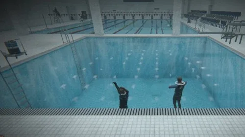 Two swimmers in an indoor pool · 室内泳池里的两个人